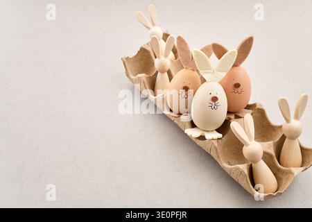 Zero waste Easter. Easter egg bunnies and wooden figures in carton Stock Photo