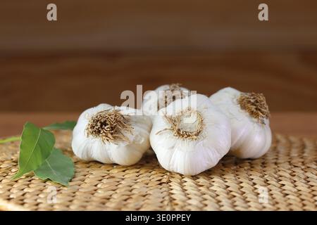 garlic bulbs (heads) on kitchen bench. Stock Photo