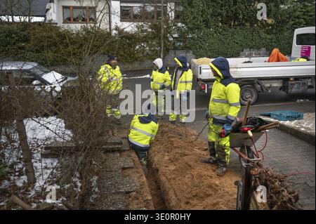 Construction crew laying Telekom fiber optic cables in a residential building, Eckental, Middle Franconia, Bavaria, Germany Stock Photo