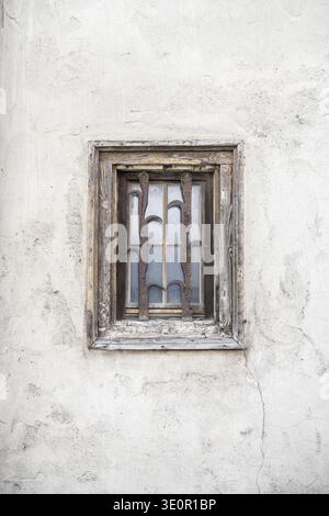 Detailed view of a historic town house in the historic old town of Rottweil with a window with weathered wooden frame and forged, rusted window grille Stock Photo