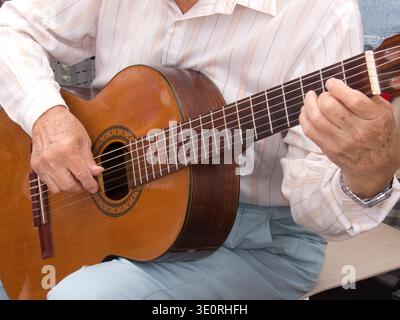 Mid section view of a man playing a guitar, Buenos Aires, Argentina Stock Photo