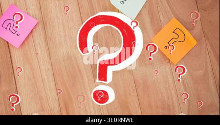 Displaying red-white ? mark centered on wood desk, cutouts, pink left, orange right, pale green top Stock Photo