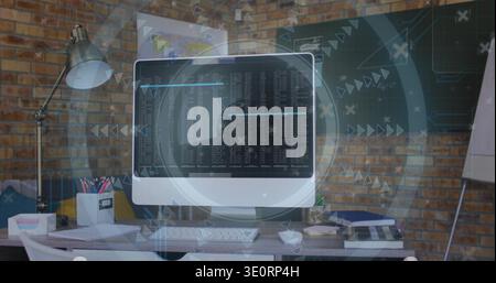 Displaying all-in-one desktop monitor revealing terminal text and HUD in loft office, with keyboard Stock Photo