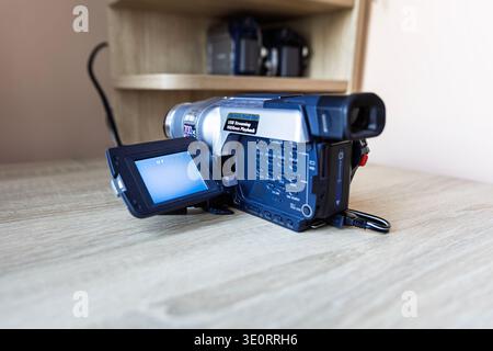 Vintage Digital8 Camcorder with Open LCD Screen on Wooden Table Stock Photo