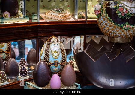 Milan, italy, april 1, 2024. Elaborate chocolate easter eggs with intricate designs, elegant decorative cakes, and confectionery items showcasing luxu Stock Photo