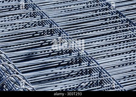 Metal grid lines stretch across the frame. Rows repeat, forming a geometric pattern. Cool blue tones dominate the surface. Structural design suggests Stock Photo