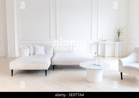 Minimalist interior design with cozy armchair and elegant decor at home. Aesthetic space flat. modern living room with white furniture Stock Photo
