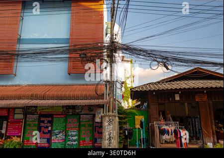 Chiang Mai, Thailand - 14.11.2025: Tangled electrical wires on utility poles in Chiang Mai Thailand, showing dense urban infrastructure, street condit Stock Photo