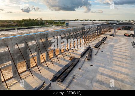 Development of commercial real estate in USA. Construction works on monolithic frame at large building site of logistics distribution warehouse Stock Photo