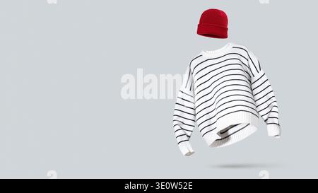 Knitted striped white sweater and red beanie hat floating on soft, light gray background. Concept of modern casual winter outfit, seasonal wardrobe an Stock Photo