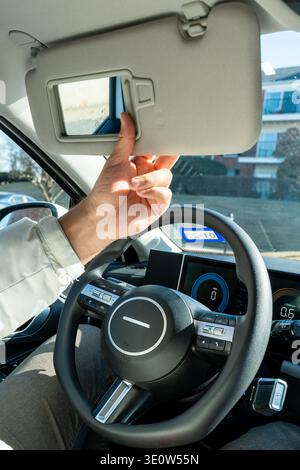 Driver Opening Sun Visor Mirror – Car Interior, Glare Protection, Sunny Day, Driving Comfort Stock Photo