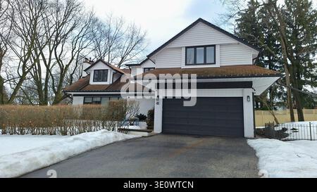 Toronto, ON, Canada - March 13, 2026: The photo shows a detached house during winter; snow is on the ground. Stock Photo