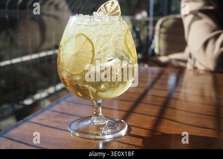 Refreshing drink served in a glass with lime slices Stock Photo