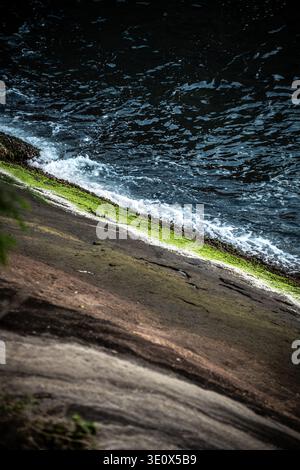 Atlantic Water Meeting Mossy Coastal Rock in Brazil Stock Photo