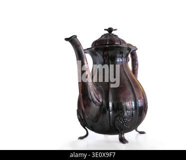 Studio, retro and brass coffee pot, victorian drinkware and decor on white background. Metal, antique container and tools for tea with copper cup Stock Photo
