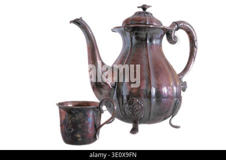 Studio, vintage and brass coffee pot, victorian drinkware and decor on white background. Metal, antique container and tools for tea with copper cup Stock Photo
