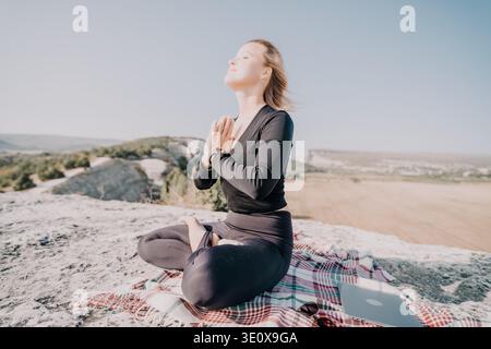 Woman Meditating on a Mountaintop Stock Photo
