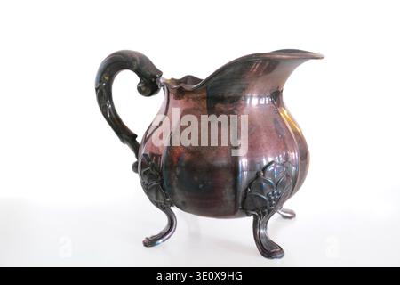 Studio, vintage or brass milk pot for coffee, victorian drinkware or decor on white background. Metal, antique creamer or container for tea with Stock Photo
