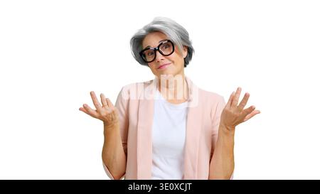 Older woman shrugging shoulders expressing doubt and uncertainty Stock Photo