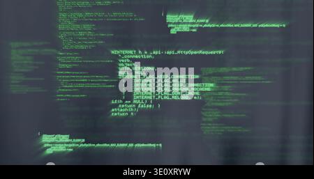 Displaying central green monospace code on dark textured screen in dim room, showing motion streaks Stock Photo