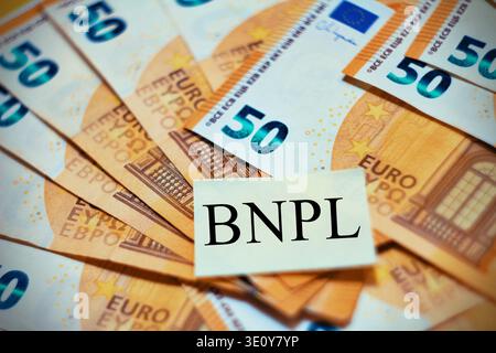 "BNPL" in the middle of banknotes, abbrevation concept of Buy now , pay Later. Stock Photo