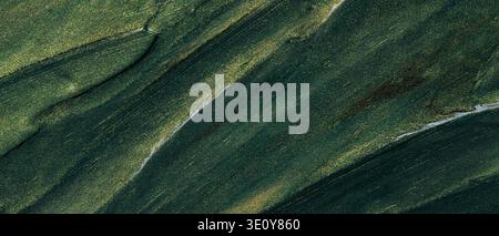 Abstract green textured background with diagonal brushstrokes and golden glitter accents Stock Photo