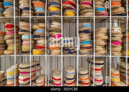 Rows of traditional colorful Spanish espadrilles on a metal rack Stock Photo