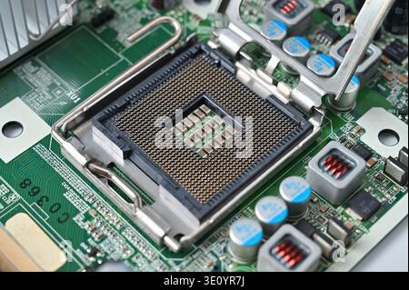 Close-up view of an empty computer motherboard CPU socket with pins and circuitry Stock Photo