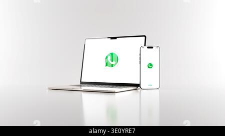 WhatsApp messaging app on smartphone and laptop in white background, digital communication concept. Rendering in 8k high resolution. Stock Photo