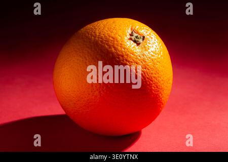 orange fruit on red background Stock Photo