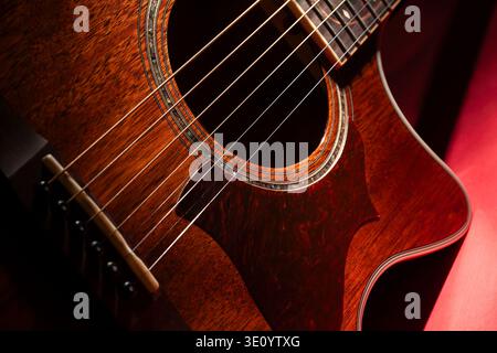 acoustic guitar on red background Stock Photo