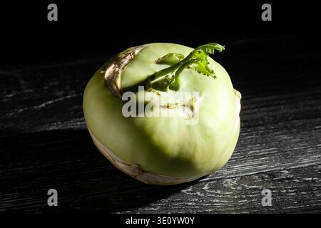 kohlrabi on black wood background Stock Photo