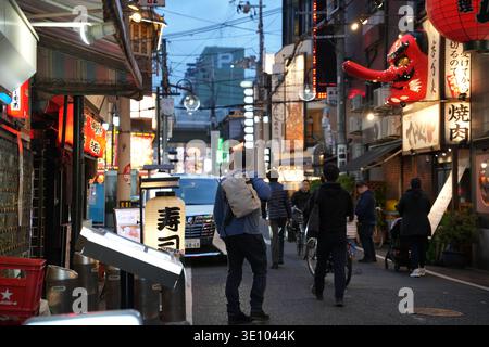 Tourist walking through Osaka street, Japan urban travel and lifestyle scene Stock Photo