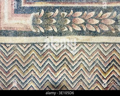 Fragmented Roman Lion Mosaic with Intertwined Border Detail 5th Century AD at Haleplibahce Museum Turkey, Ancient Damaged Predator Figure and Pattern Stock Photo