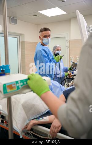 Male medical professional with endoscope in operating room Stock Photo