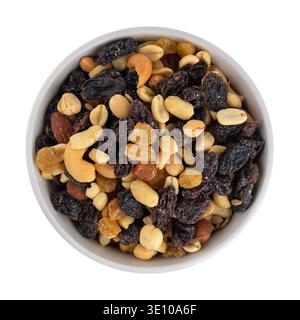 High energy trail mix with roasted nuts and fruit in a colorful bowl top view. Stock Photo
