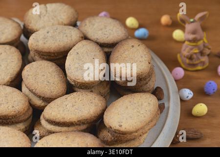 Baked cookies in the shape of eggs next to Easter decoration Stock Photo