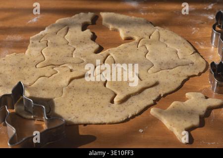 Dough with cut-out cookies in the shape of Easter bunnies Stock Photo
