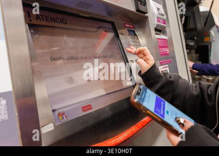 User interacting with the interface of a Renfe ticket machine in Xativa on March 14, 2026, Spain Stock Photo