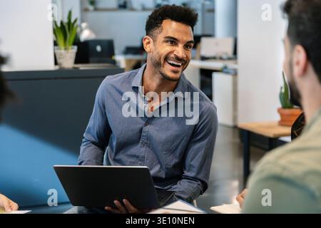 Business professional discussing work during team meeting Stock Photo