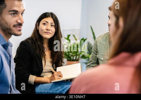 Diverse professionals collaborating during business meeting Stock Photo