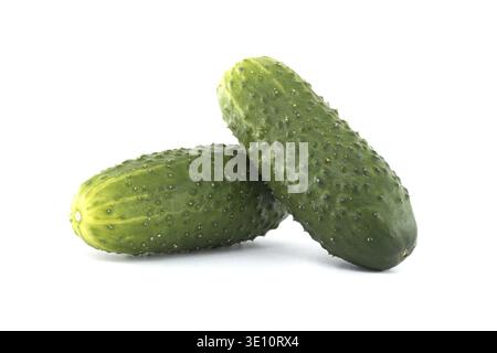 Two fresh, green cucumbers rest against each other, isolated on a clean, bright white background, perfect for various culinary and health-related proj Stock Photo