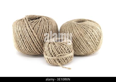 Three balls of natural twine are isolated on a white background. The twine is a rustic, earthy tone, and the balls vary in size, providing visual inte Stock Photo