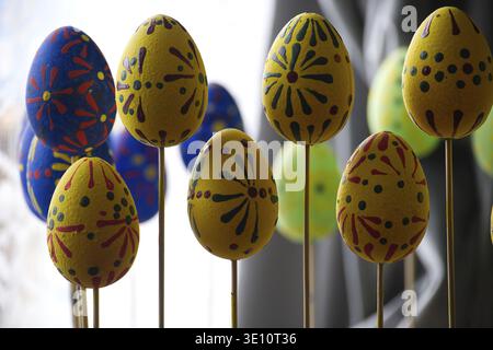 Vibrant Easter eggs on display, showcasing colorful patterns and designs, perfect for holiday decorations. These eggs are mounted on sticks, enhancing Stock Photo
