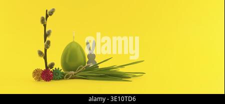 Brighten your designs with this cheerful Easter composition on a yellow background, featuring a green egg candle and willow Stock Photo