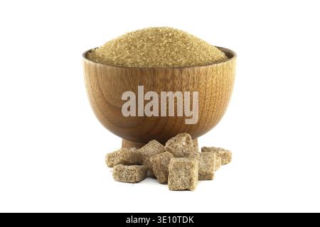 A wooden bowl is filled with granulated brown sugar, with sugar cubes scattered below, set against a clean white background Stock Photo
