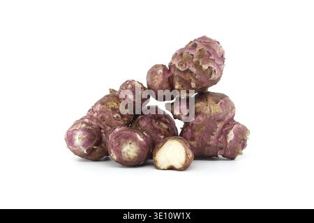 A stack of fresh purple Jerusalem artichokes, showcasing their unique texture and color against a white background. Ideal for use in culinary or agric Stock Photo