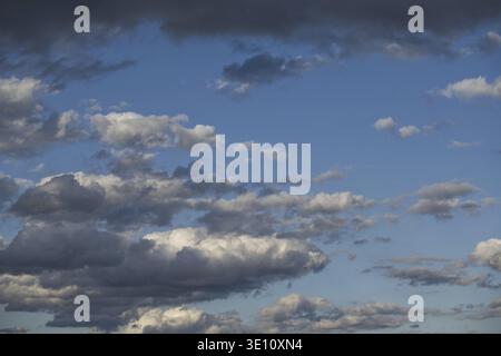 Dramatic clouds in a blue sky create a striking contrast, showcasing nature's beauty and changing weather patterns Stock Photo