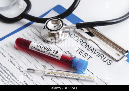 Coronavirus testing. Close-up of the blood sample and thermometer Stock Photo