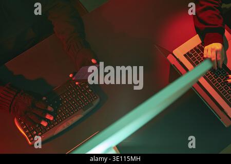 Anonymous people using computer and programming to break code. Cyber security threat. Internet and network security. Access to private information. An Stock Photo